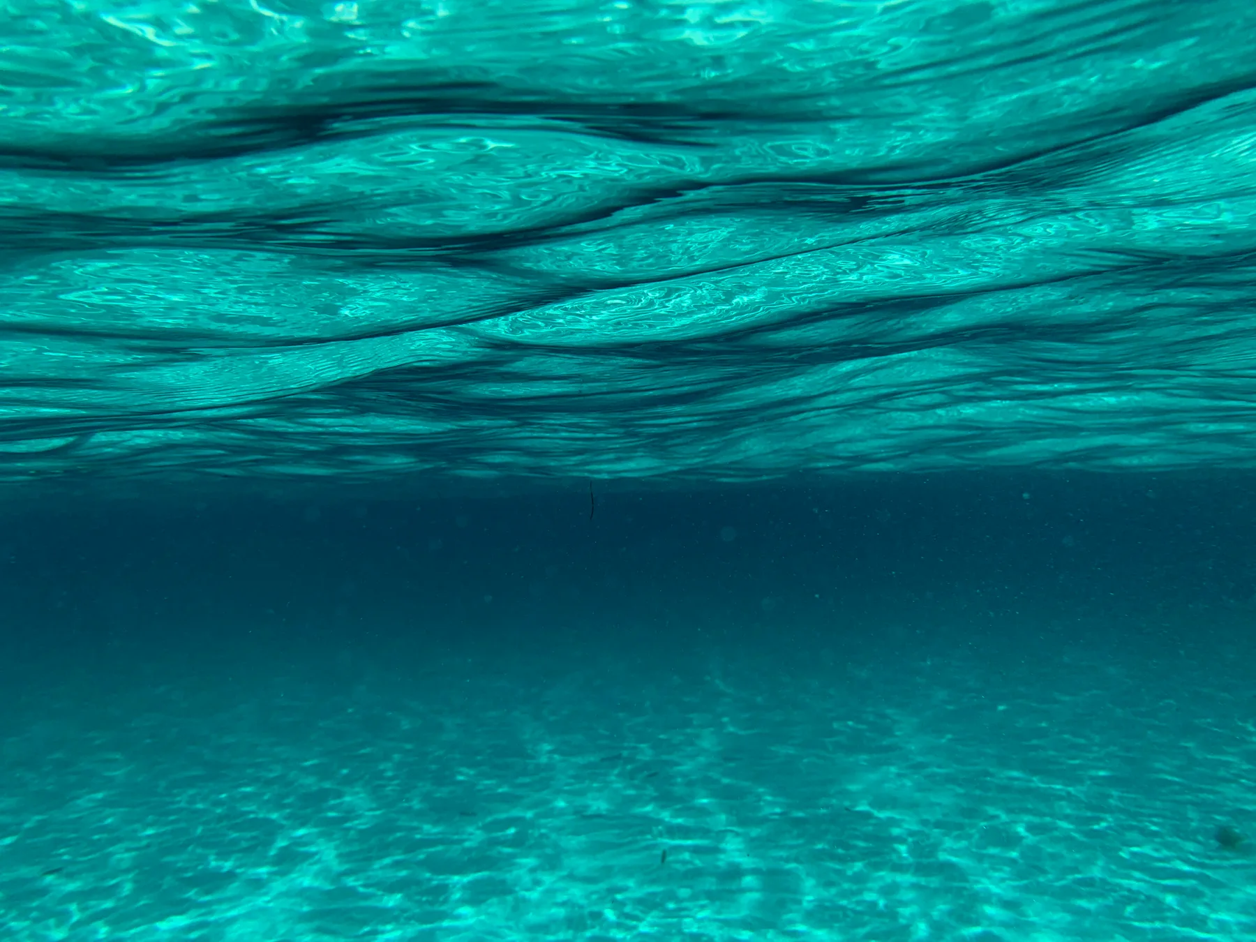 Sunlight rippling across clear shallow water in Mexico