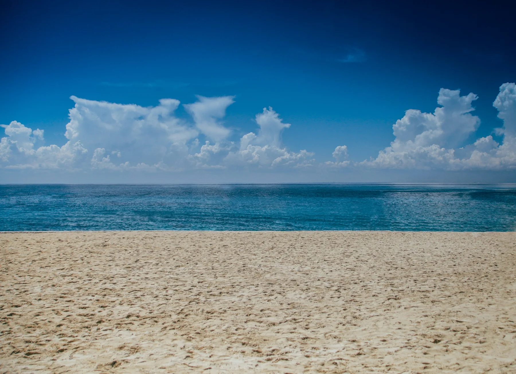A quiet stretch of Cozumel shoreline beneath Caribbean clouds
